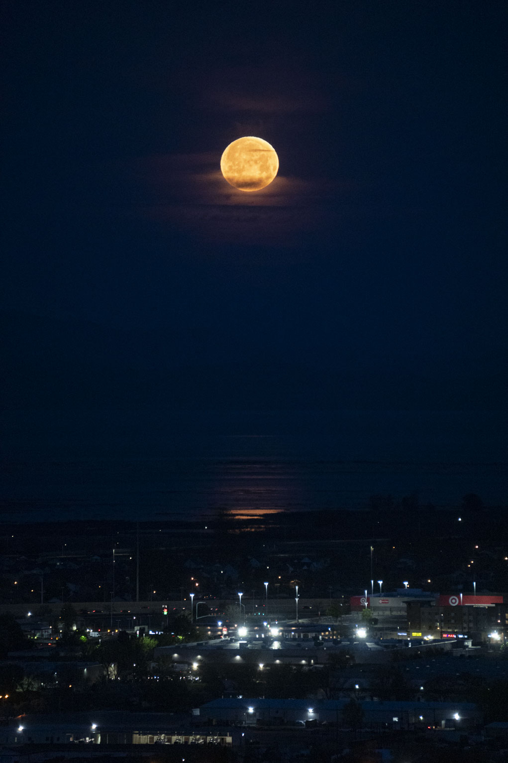 Orange moon sets in deep blue dawn